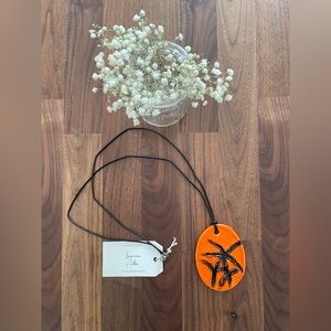 Handmade necklace, orange with black design
